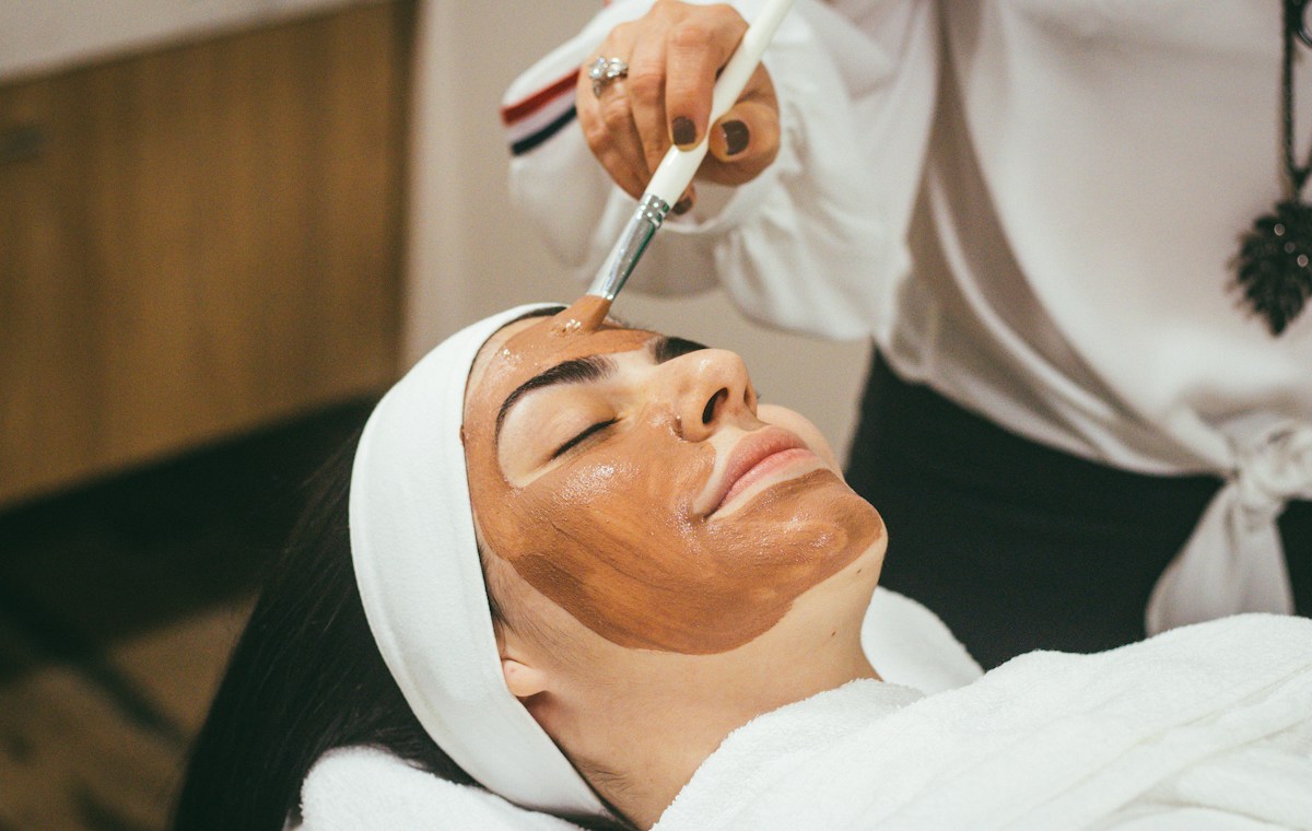 A facial mask being applied during a spa treatment
