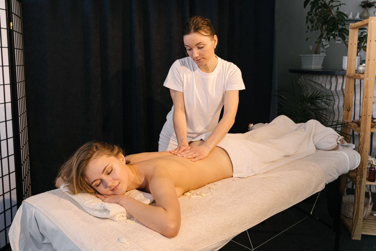 A therapist giving a relaxing back massage in a spa